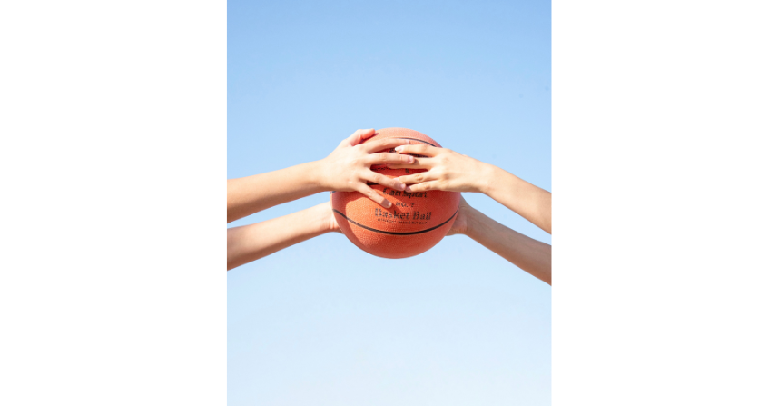 Basketball der von zwei Kindern gehalten wird
